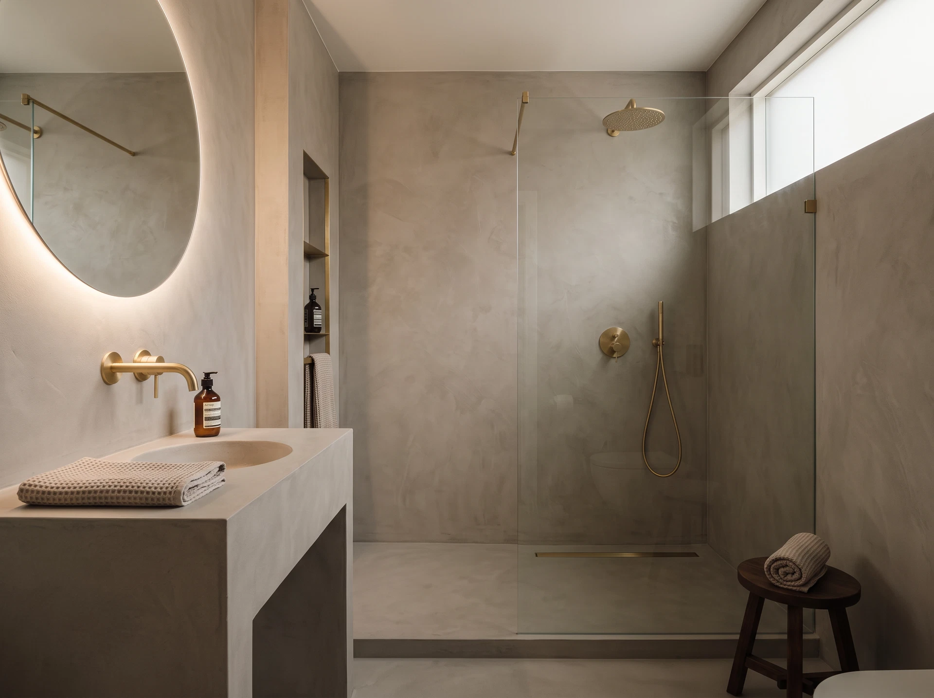A seamless warm-grey micro-cement bathroom with no grout lines