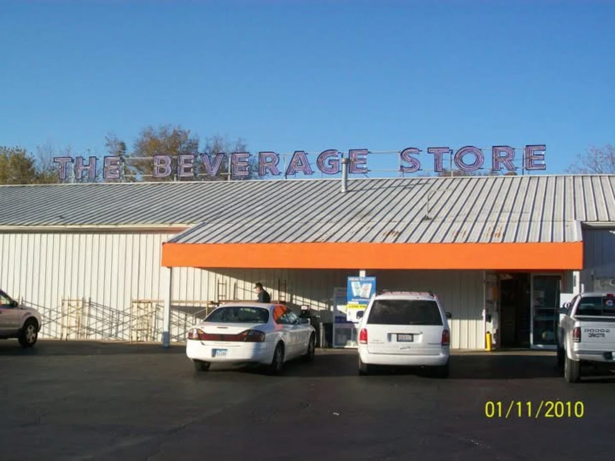 After: front view of The Beverage Store with a bright-orange finished EIFS entry fascia below the store sign