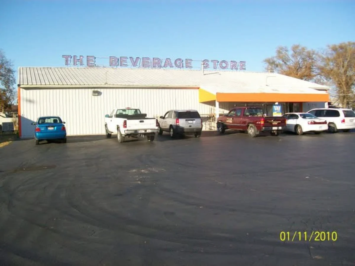 After: The Beverage Store with the completed bright-orange EIFS facade and a clean finished storefront