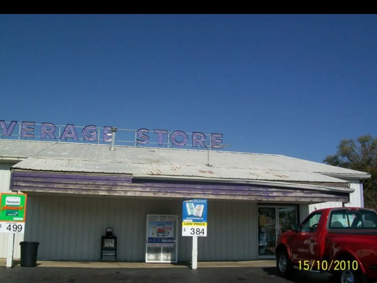 Before: The Beverage Store storefront with a weathered facade and faded purple wood across the front
