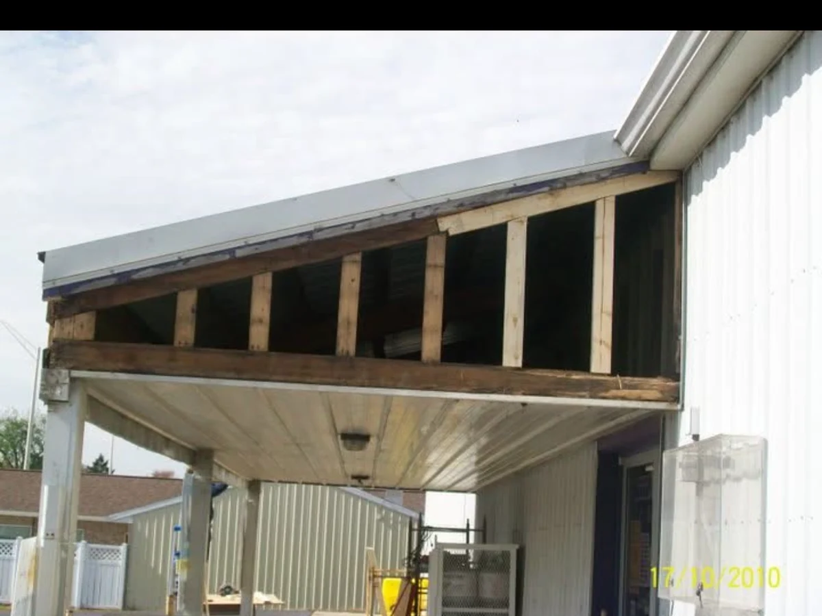 In progress: exposed studs and open facade at the storefront while the new wall assembly is being prepared