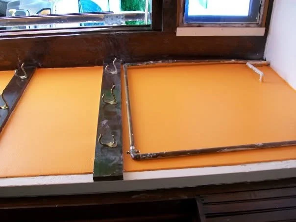 Orange-painted foyer panels framed by the original dark wood trim and coat hooks
