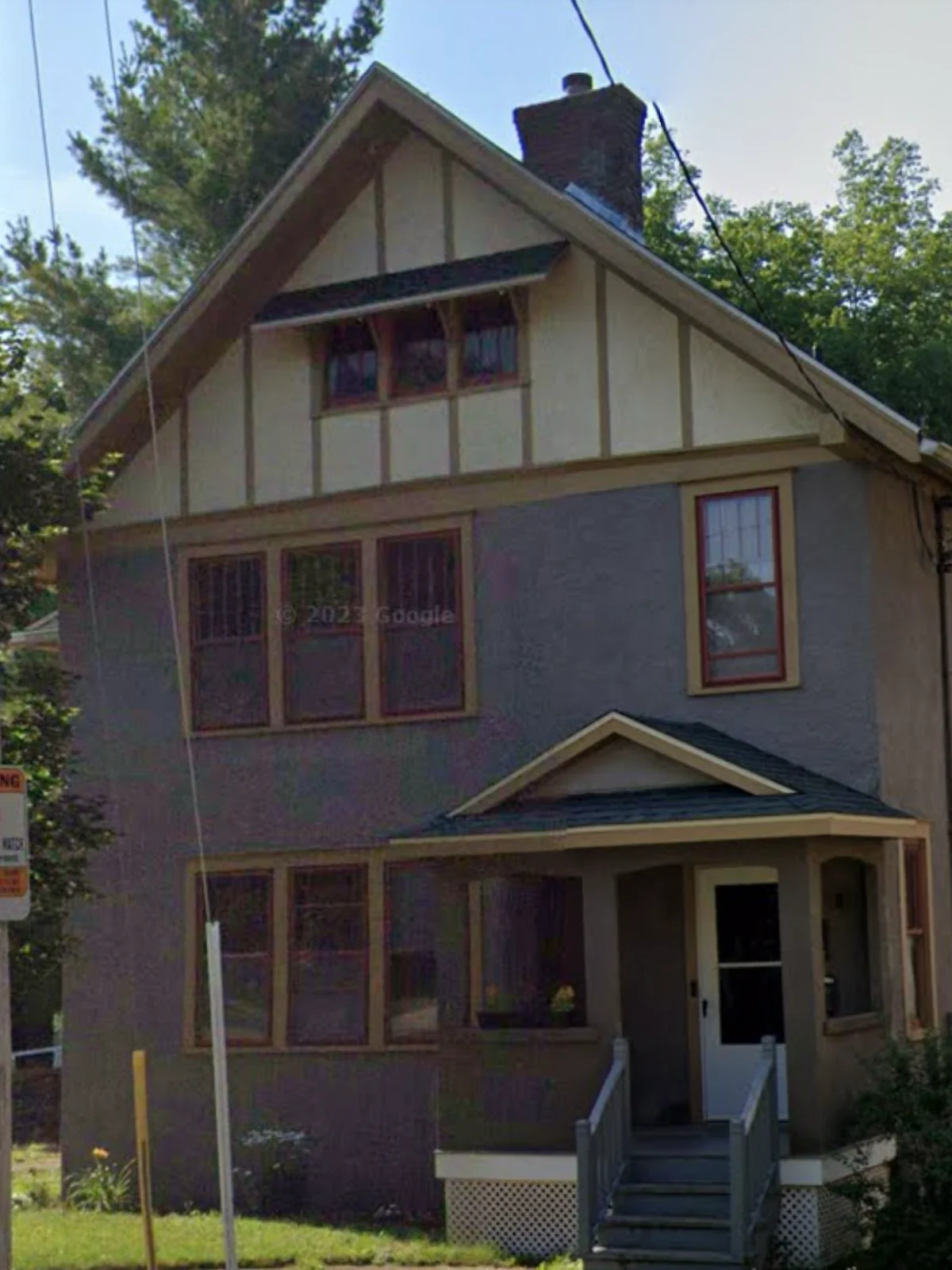Before: the front of a two-story Dixon residence with dark painted siding, brown trim and a weathered exterior finish