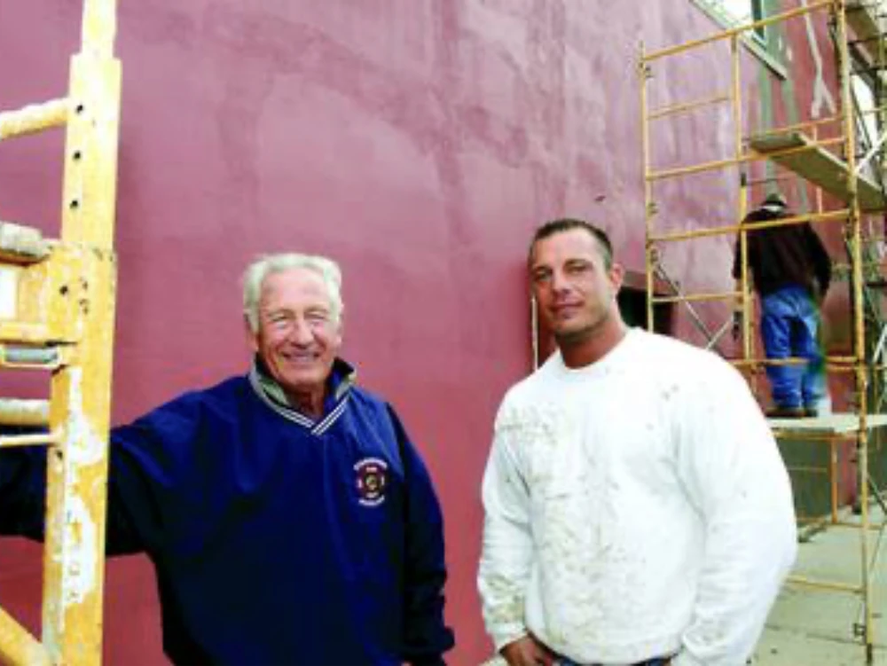 Father and son, second and third generations of the family plastering business, on a plastering job in Morrison, Illinois, 2014