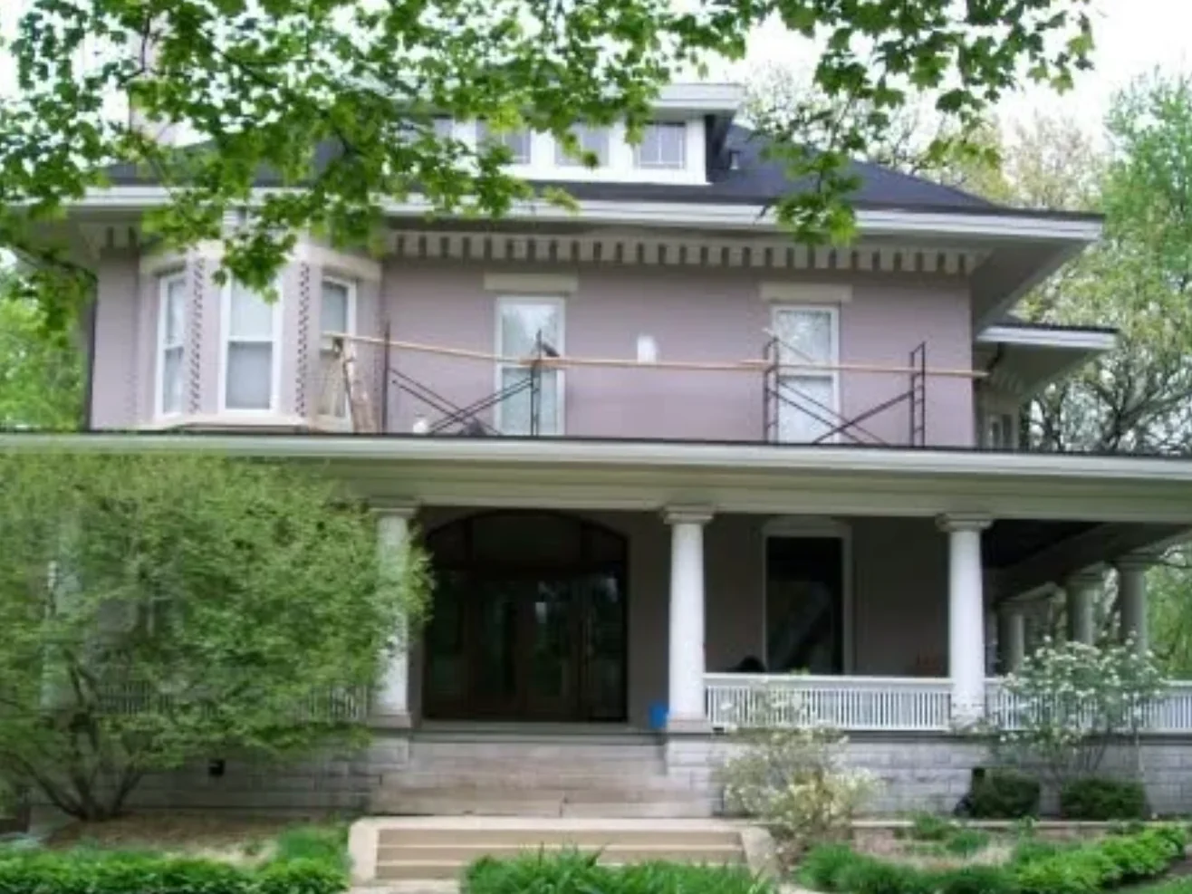 The Frank Lloyd Wright Prairie home in Oak Park, with scaffolding along the second floor beneath the wide eaves during the soffit work