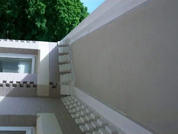 Finished: the soffit feathered into the original and painted to match beside the dentil corner