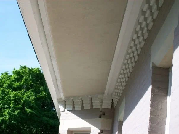 After: the wraparound soffit and dentil trim, finished and painted to match, seen from below