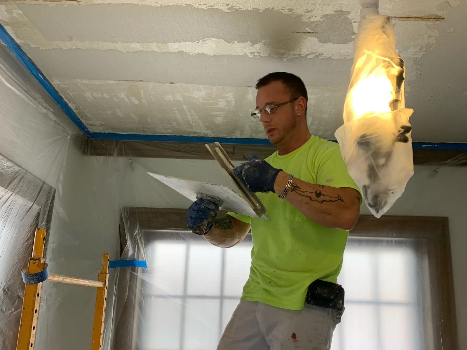 Our third-generation plasterer with hawk and trowel, restoring a plaster ceiling in a historic room