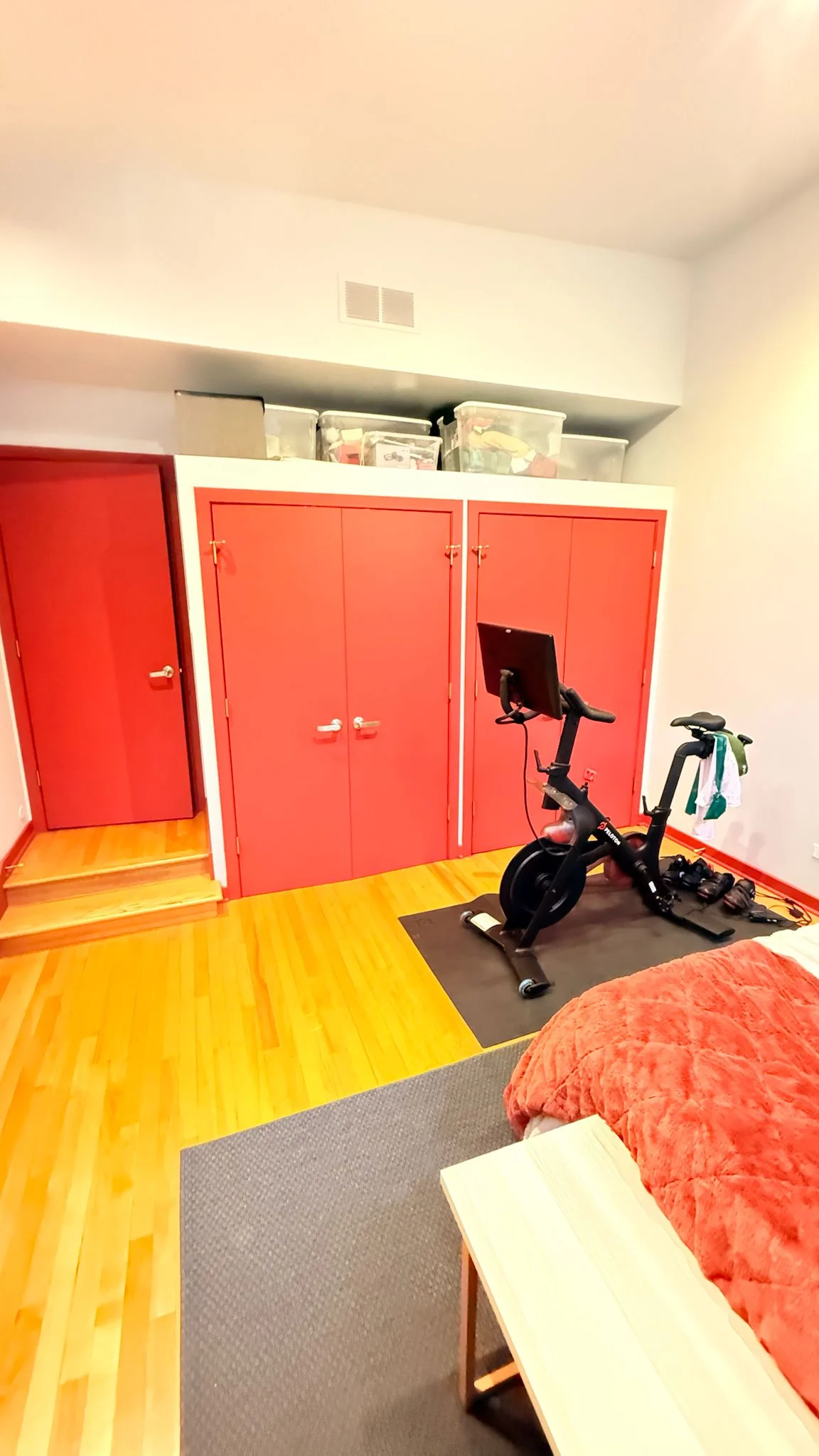 After: the closet doors and the door beside them painted a rich red