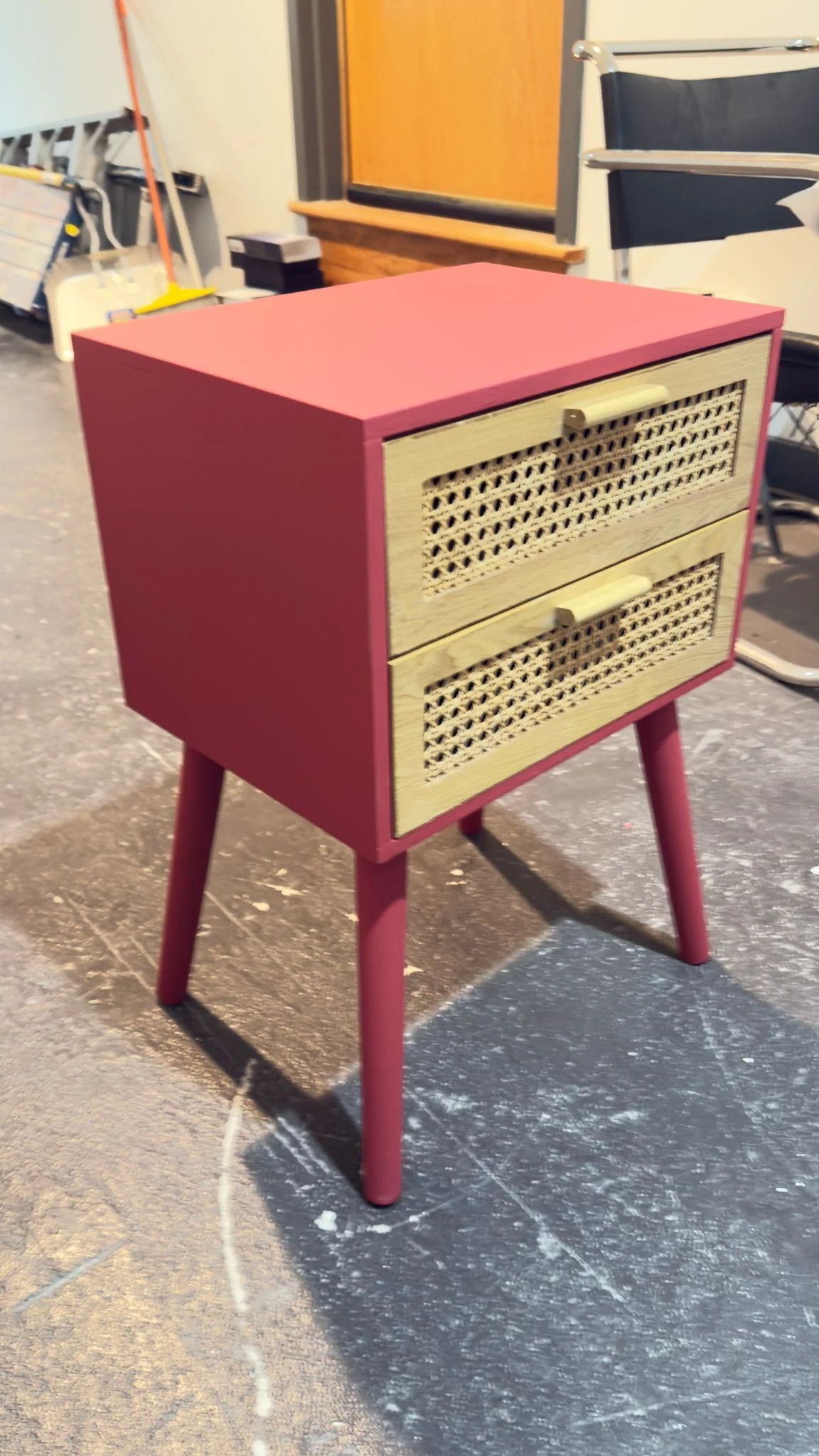 After: the same nightstand refinished in red, with the cane-front drawers kept natural