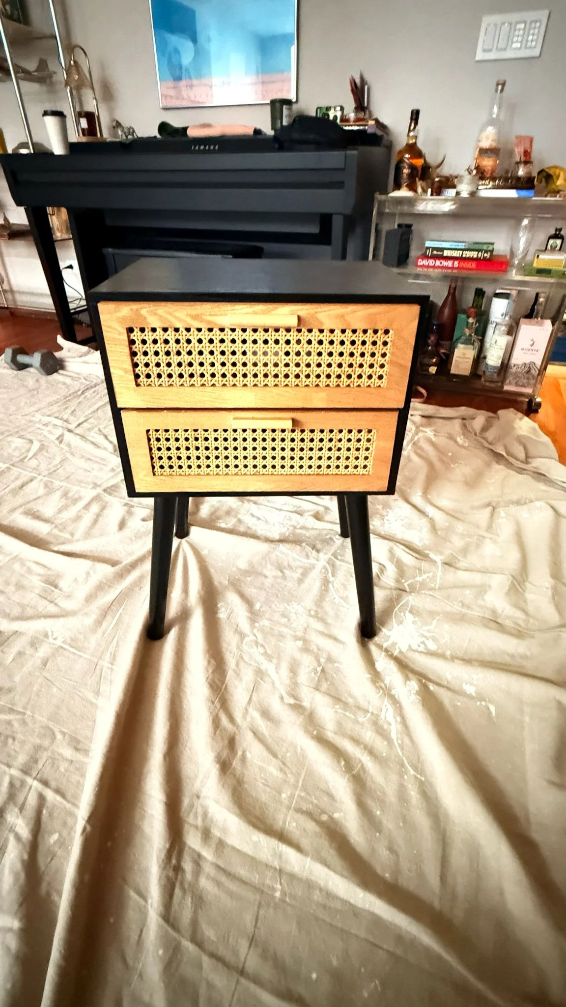 Before: a black nightstand with two cane-front drawers