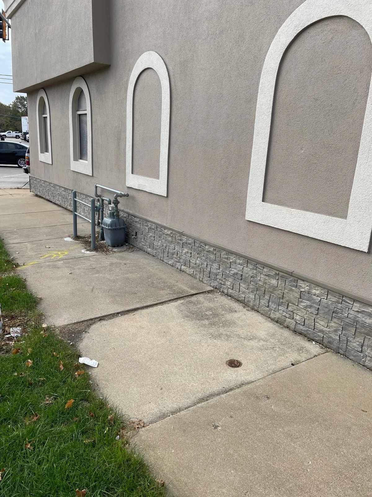 After: the finished side elevation of the restaurant from the sidewalk, arched trim and EIFS wall fully restored
