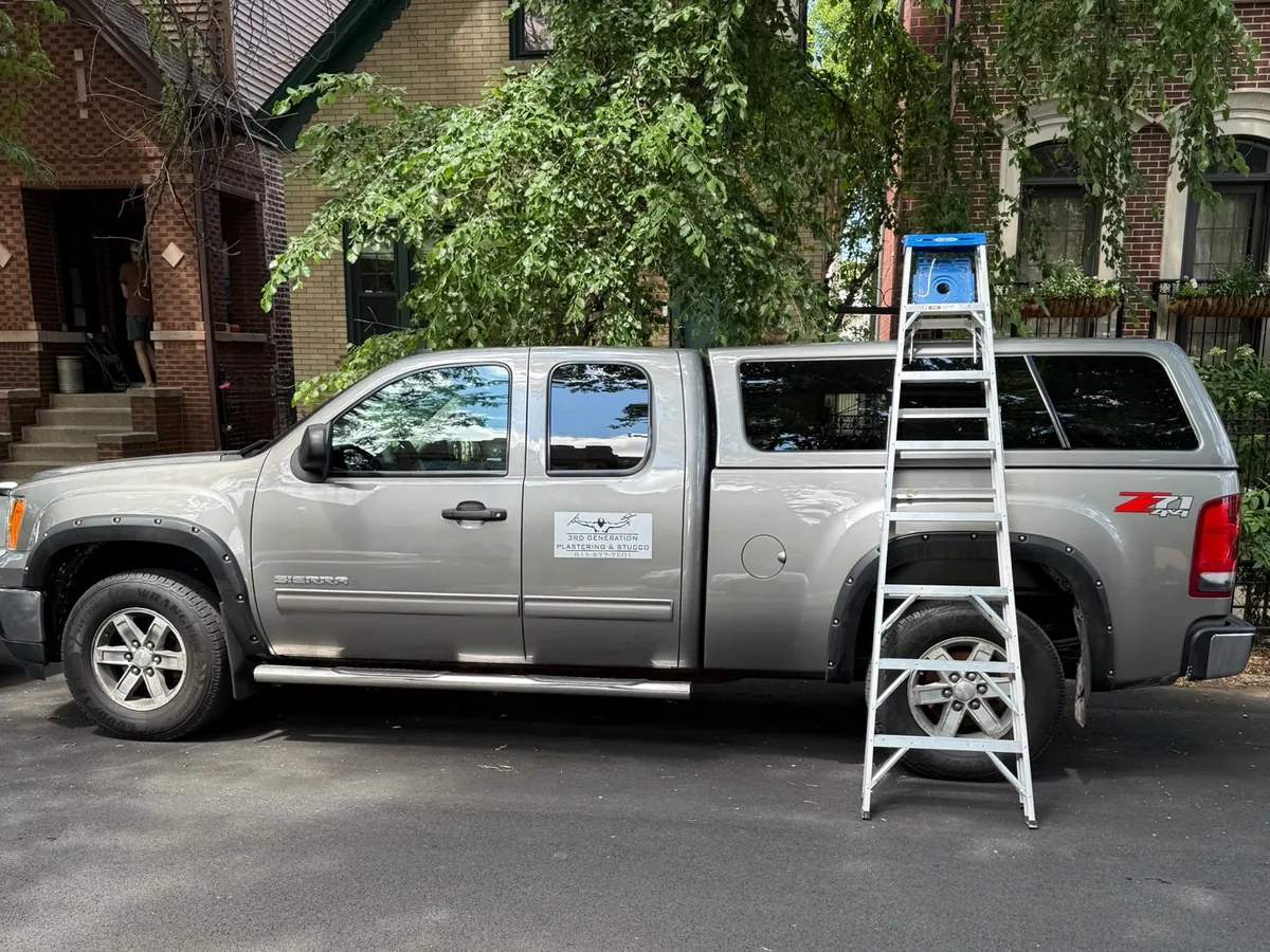 On site: Ladder up and truck at the curb, another wall underway.