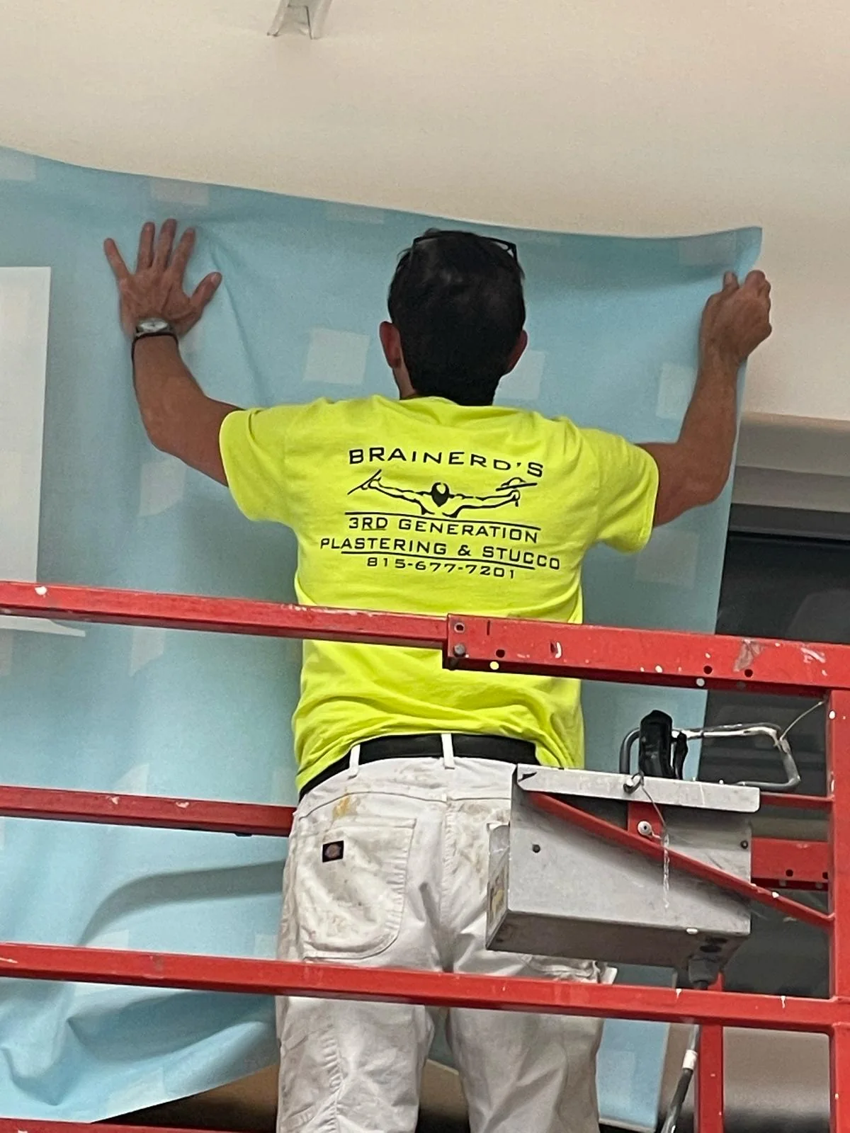 Wall coverings: Hanging a commercial wall covering from the lift.